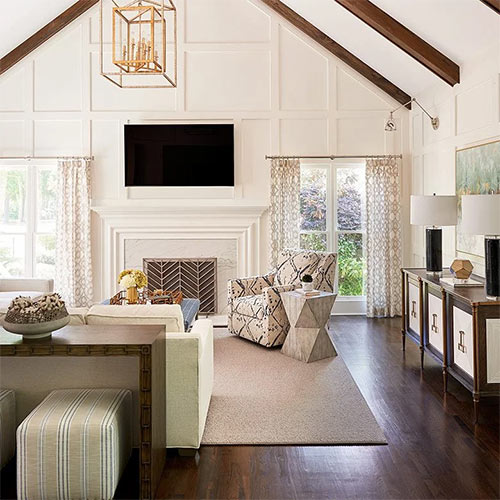 A cozy living room with a fireplace and a big TV.